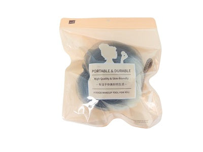 Colored shower ball in clear packaging, dark gray round bath sponge